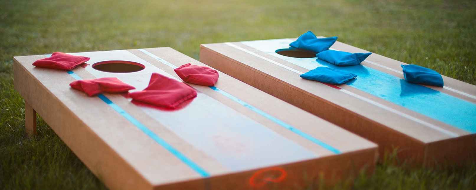 a set of corn hole boards in the grass